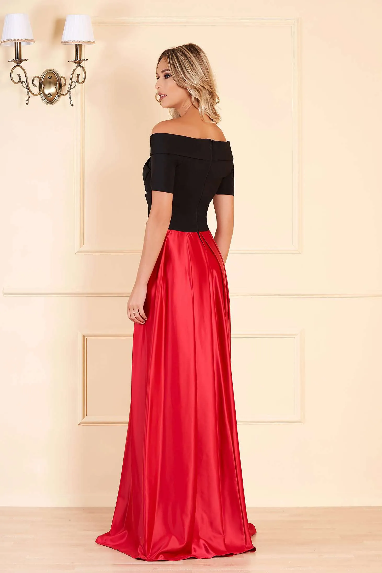 Black bodice artist long dress with red flared skirt and embroidered waist.