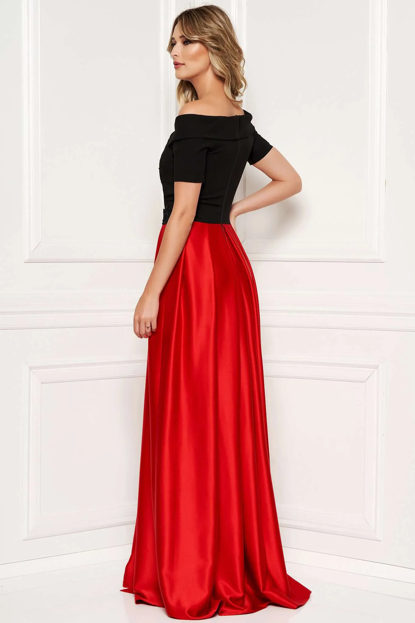 Black bodice artist long dress with red flared skirt and embroidered waist.