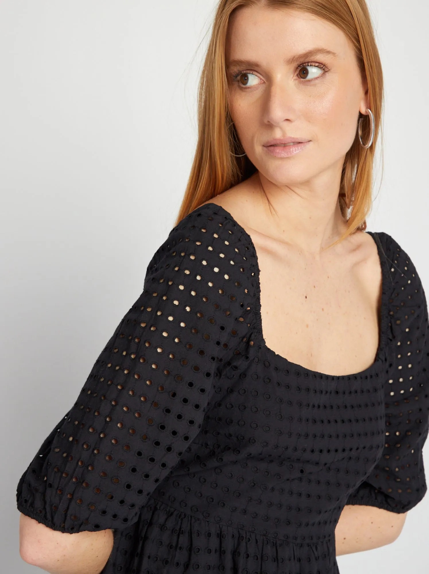 Black puffed dress with pierced embroidery