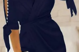 Dark blue Candys mini dress with faux pearl detailing and wrap neckline.
