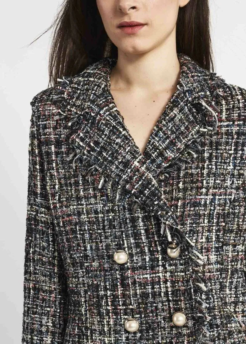 Double-breasted jacket with fringed edges.