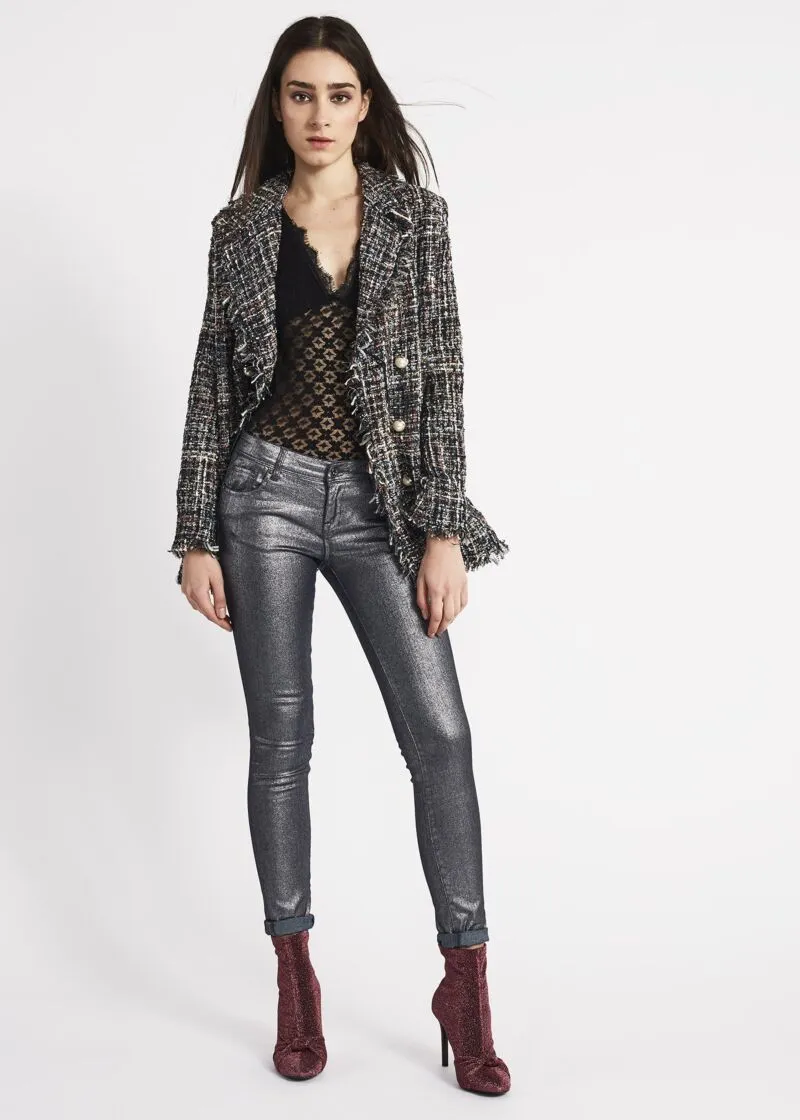 Double-breasted jacket with fringed edges.