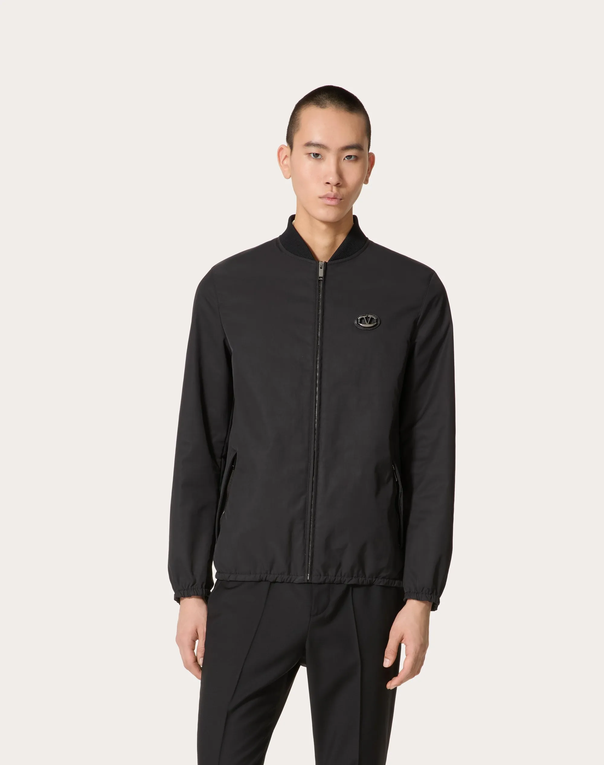 Nylon jacket with leather patches and signature V-logo.