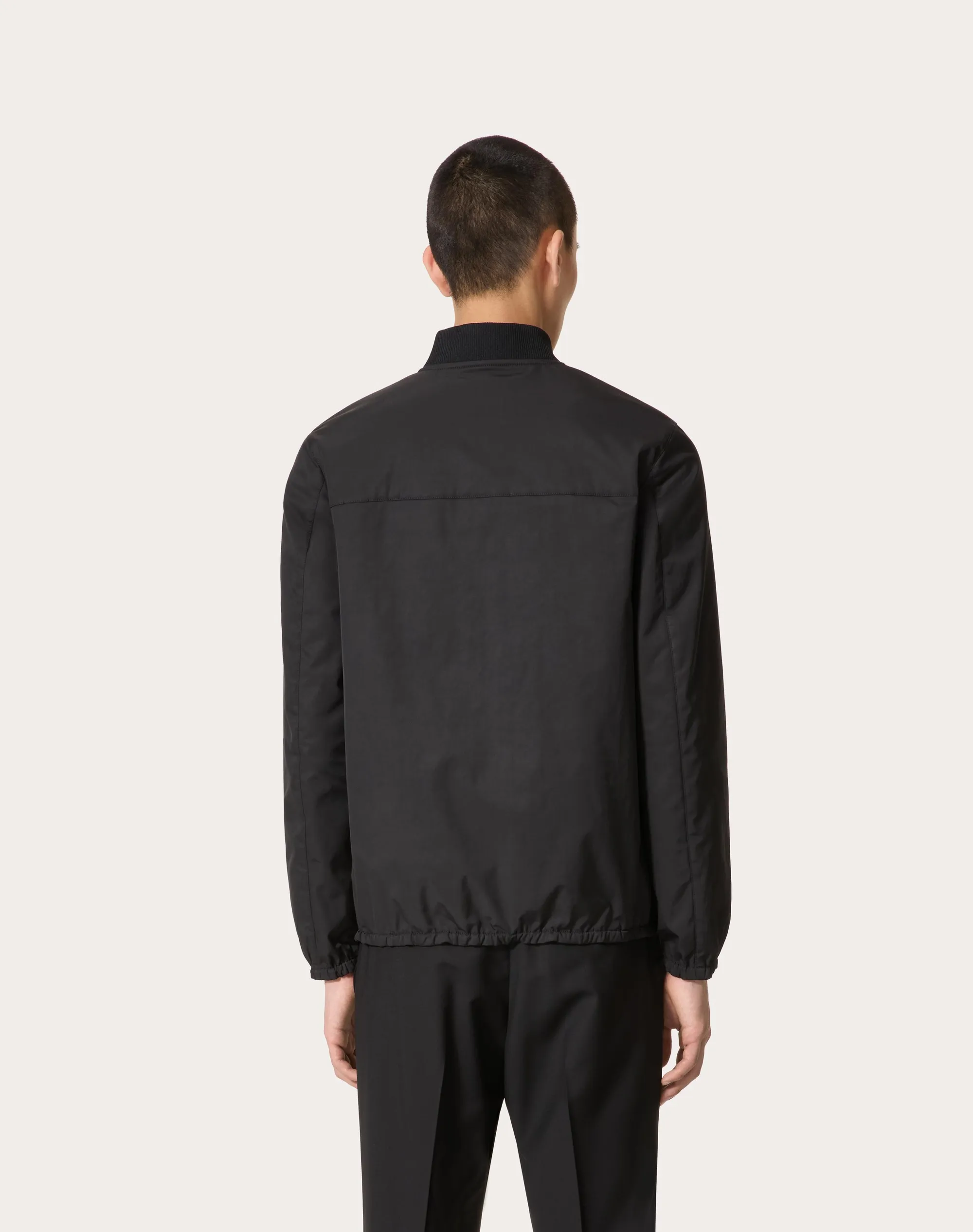 Nylon jacket with leather patches and signature V-logo.
