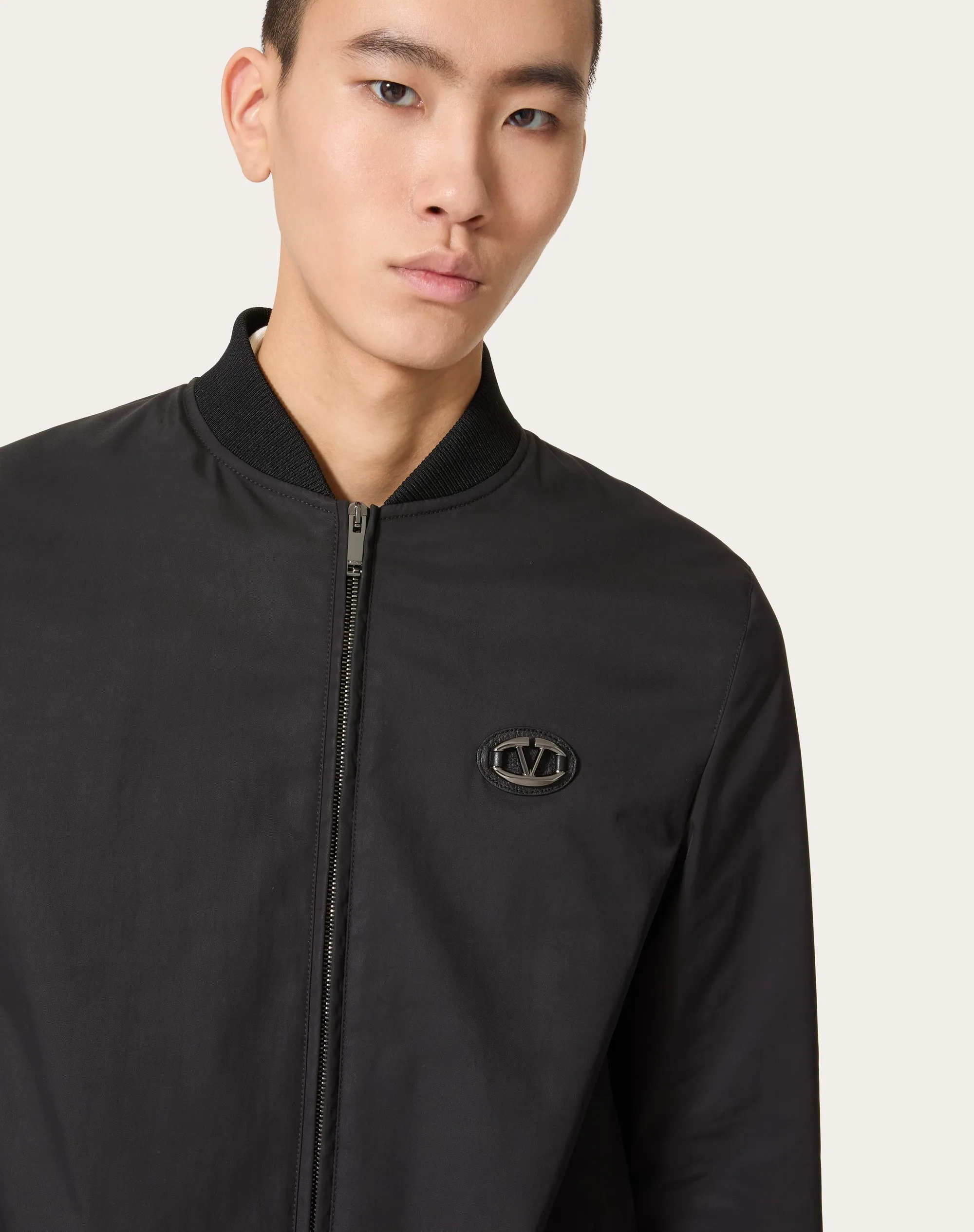 Nylon jacket with leather patches and signature V-logo.